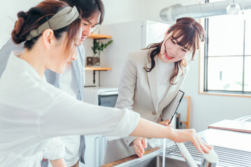 Fototapeta premium キッチンの設備を説明する女性（水道） 