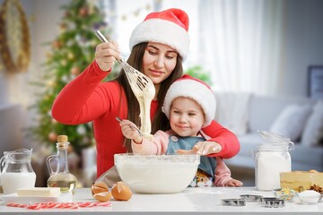 Obraz na płótnie Canvas happy Mother and daughter preparing cream puffs