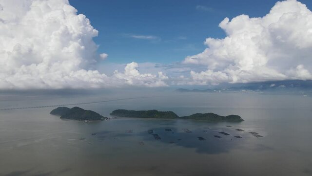 Aerial fly toward Pulau Aman and Pulau Gedong in blue sunny day