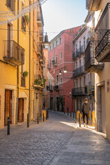 Traditional Girona narrow street, with unrecognizable young man on it