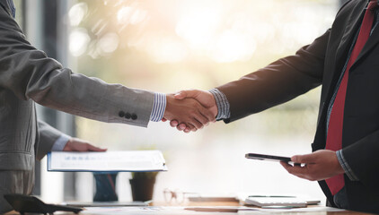 Obraz na płótnie Canvas Negotiating business,Image of businessmen Handshaking,happy with work, Handshake Gesturing People Connection Deal Concept. Cropped image.