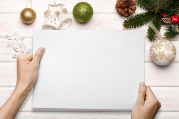 Woman hands holds christmas mockup. Christmas Recipe Menu on rustic wooden background.