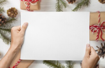 Woman hands holds christmas mockup. Christmas Recipe Menu on rustic wooden background.
