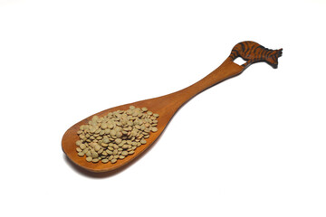 Pile lentil in wooden spoon isolated on white background. Top view.	