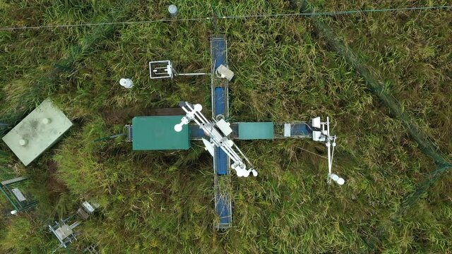 Wetlands science station research for studying meadows, drone aerial video shot ecosystem weather station swamp willows cycle carbon flux eddy covariance methane research physiological photosynthesis