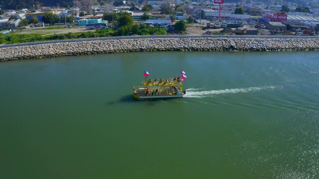 boat ride on the Maule river of constituci&oacute;n chile. drone shot tracking