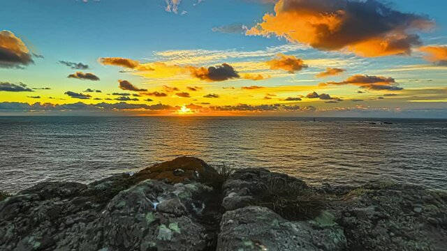 magic colored sky at sunset hour on the ocean in Guernsey island, coast of Normandy. Hyperlapse