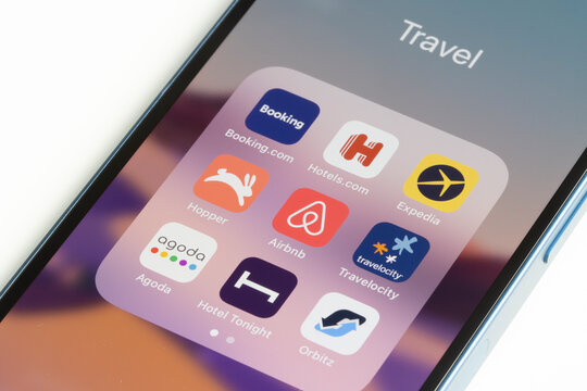 Portland, OR, USA - Dec 23, 2021: Assorted travel apps are seen on an iPhone, including Booking.com, Hotels.com, Expedia, Hopper, Airbnb, Travelocity, Agoda, Hotel Tonight, and Orbitz.