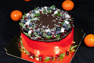 Christmas Day Cake Decoration. Holiday Cake round shaped on a gold substrate on black background.