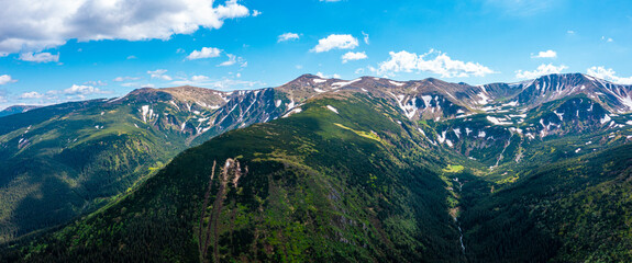 Fototapeta premium Panorama of beautiful countryside of Switzerland. Sunny afternoon. wonderful springtime landscape in mountains. Grassy field and rolling hills. rural scenery