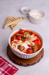 Beans soup with vegetables and sausages