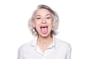 Shot of a beautiful mature woman having fun and teasing sticking out her tongue isolated on white background