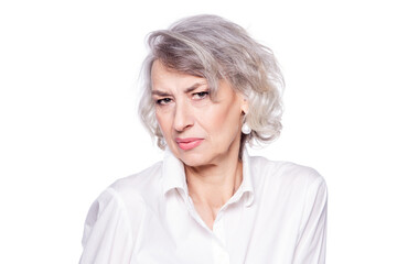 Displeased retired old woman with wrinkled well cared face looks disappointed looking suspiciously...