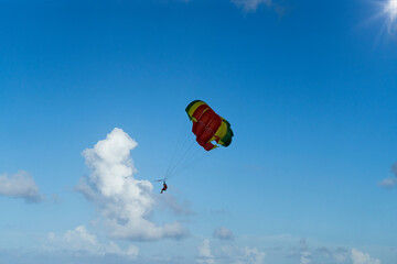 Couple under parachute hanging in mid air.