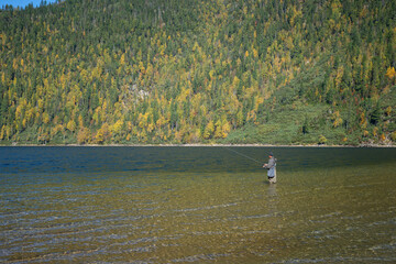 Fototapeta na wymiar Fishing on Soboliniy Lake in the choirs of the Khamar-Daban ridge 