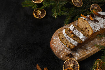 Christmas cake with nuts and dried fruits sliced on a board