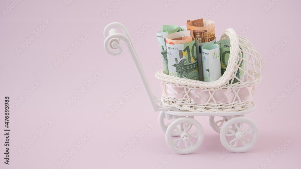 Wall mural in the baby stroller there are euro bills. the concept of spending on a newborn. the concept of assi