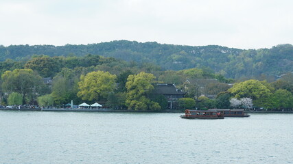 The beautiful lake landscapes in the Hangzhou city of the China in spring with the peaceful lake and fresh green mountains