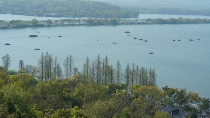 The beautiful lake landscapes in the Hangzhou city of the China in spring with the peaceful lake and fresh green mountains