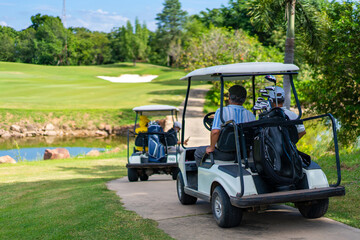 Group of Asian people businessman and senior CEO enjoy outdoor activity lifestyle sport golfing together at golf country club. Healthy men golfer driving golf cart on golf course in summer sunny day - Powered by Adobe