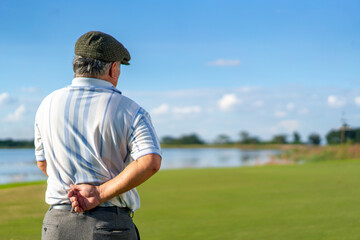 Asian senior man caught his injury back pain while golfing at country club on summer vacation....