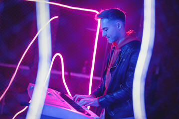 A musician is playing on the synthesizer at the scene.