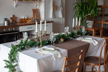 New Year's table setting. Waiting for Christmas. Kitchen interior with decoration. 