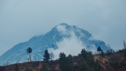 Clouds on the top of the mountain covered by snow after snowfall in Manali, Himachal Pradesh, India