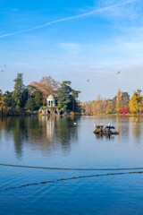 Fototapeta premium Vincennes, the temple of love and artificial grotto on the Daumesnil lake, in the public park, in autumn 