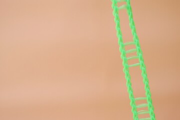 Colourful candles isolated in the green rope on pink background. Birthday,Christmas and special greetings concept. © Hari