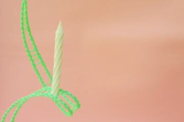 Colourful candles isolated in the green rope on pink background. Birthday,Christmas and special greetings concept. © Hari