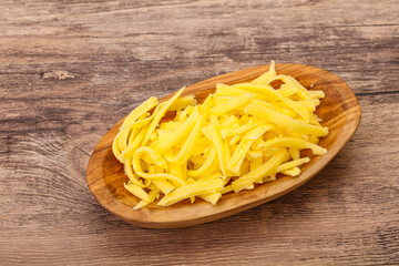 Shredded yellow cheese in the bowl