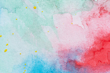 Macro close-up of an abstract colorful watercolor gradient fill background with watercolour stains and drops. High resolution full frame textured white paper background.