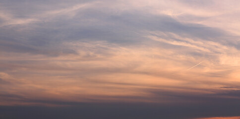Naklejka na ściany i meble Waves of Evening Clouds under Sunset