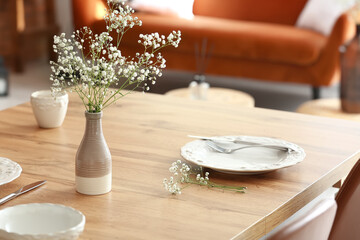 Beautiful table setting with vase and gypsophila flowers in room - Powered by Adobe