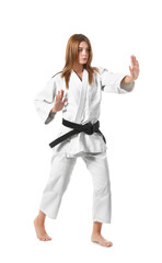 Young woman practicing karate on white background