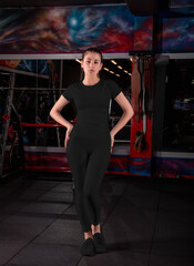 Fototapeta na wymiar Fashionable black compression underwear template on slender girl posing in the gym.
