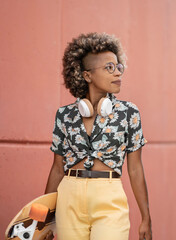 Fototapeta na wymiar afro american woman, skateboard, headphones