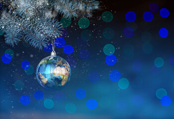 Fototapeta na wymiar Christmas background in blue. Big ball - land on a spruce branch and bokeh. New Year's planet. For the design of banners and postcards.