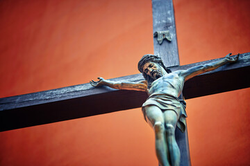 Catholic cross with crucified Jesus Christ statue over rough background. Crucifixion. Jesus Christ...
