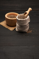  pouch full of Organic natural chia seeds on dark wooden background or table