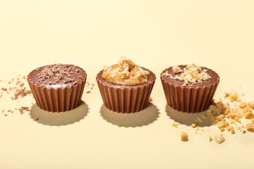 Tasty peanut butter cups on light background