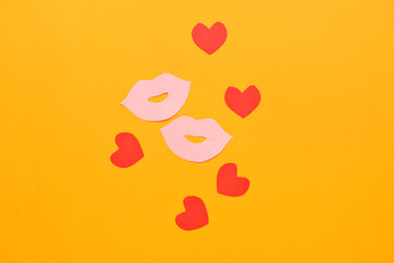 Paper female lips and hearts on color background. LGBT concept