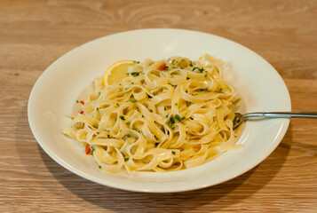 Italian Lemon Pasta or Tagliatelle al Limone on a White Plate with Parsley