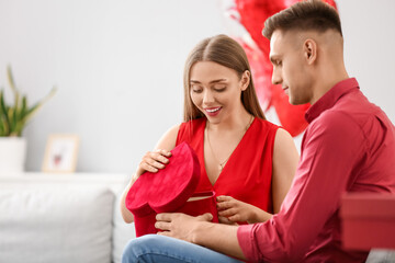 Happy couple celebrating Valentine's Day at home