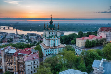 Fototapeta na wymiar Aerial view of St. Andrew's Church during dawn, one of the most famous sights of the city of Kiev. Cityscape concept, tourism, vacation, travel