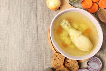 Concept of cooking chicken soup on wooden background