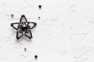 White background with handmade brooch black star