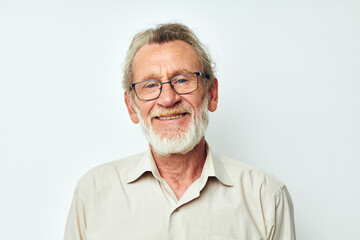 Portrait of happy senior man with a gray beard in a shirt and glasses isolated background