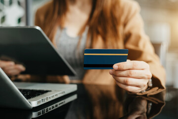 Female use computers and tablet to pay through credit card payment channels. Online shopping sit at the desk.
